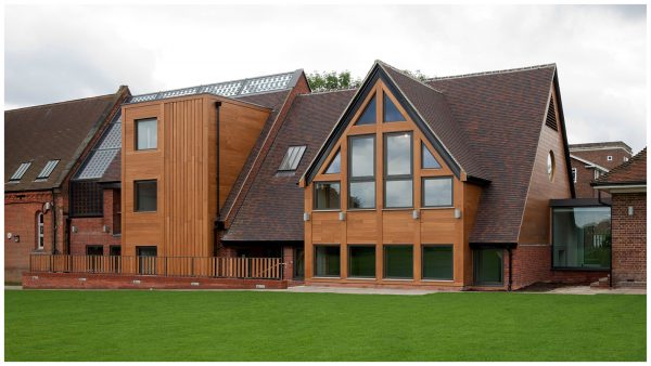 West facing facade of the new music block addition for Aldenham school, featuring multi-stock brick, stained hard-wood timber cladding and solar controlled glazing