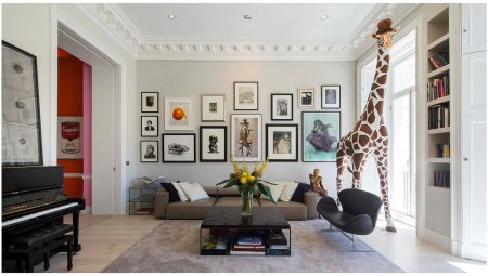 Reception room in a listed flat with picture gallery above a seating area and recessed, built-in book case; neutral décor to showcase the modern art