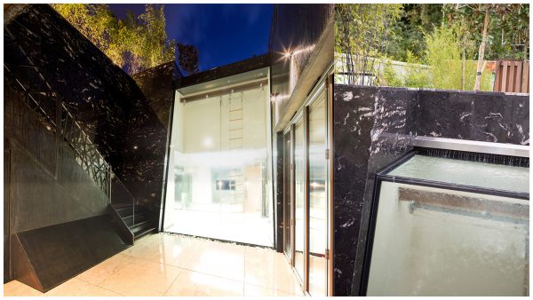 Marble clad lightwell basement walls with feature external staircase & water feature set over double height glass extension