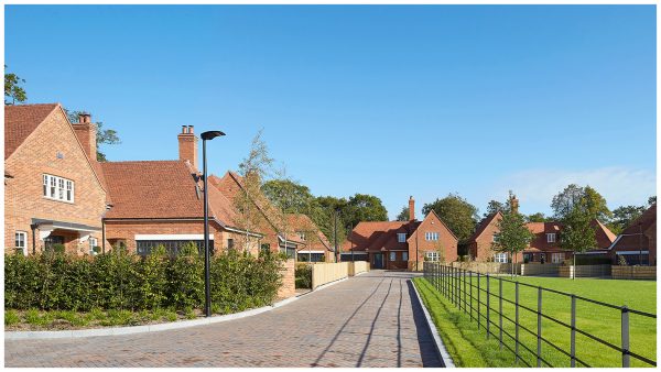Street view of Wood Farm, a green belt development at the edge of Stanmore village, showing the different house types and communal green space